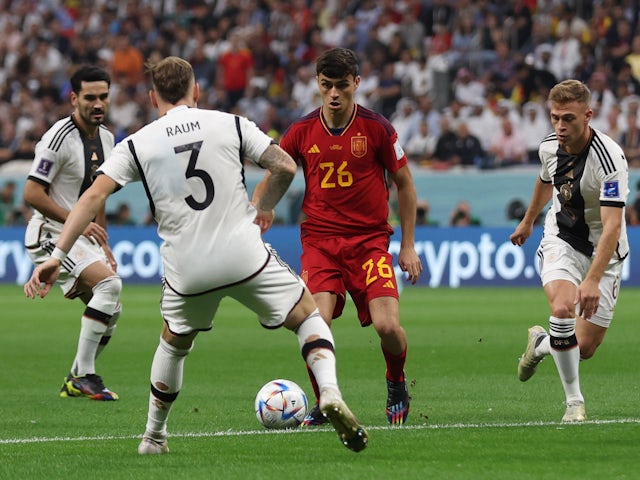 Spain's Pedri in action with Germany's David Raum at the World Cup on November 27, 2022