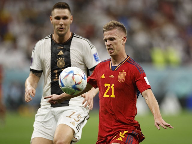 Spain's Dani Olmo in action with Germany's Niklas Sule at the World Cup on November 27, 2022