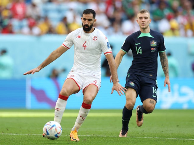 Tunisia's Yassine Meriah in action with Australia's Riley McGree at the World Cup on November 26, 2022