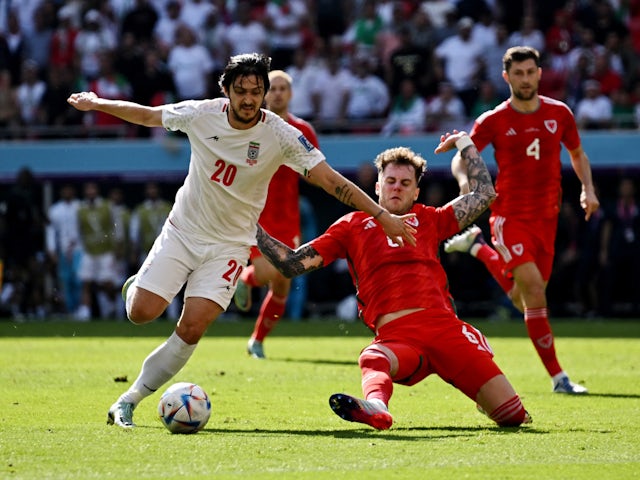 Wales defender Joe Rodon tackles Iran's Sardar Azmoun on November 25, 2022