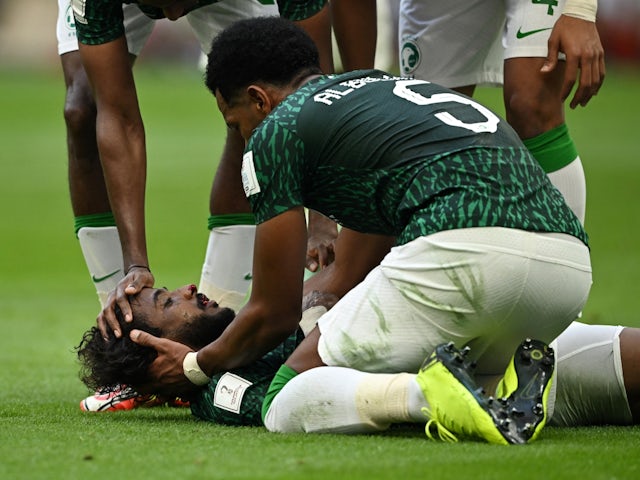 Saudi Arabia's Yasser Al-Shahrani after sustaining an injury as Ali Al Bulayhi looks on, on November 22, 2022