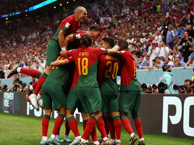 Portugal's Cristiano Ronaldo celebrates scoring their first goal with teammates on November 23, 2022