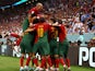 Portugal's Cristiano Ronaldo celebrates scoring their first goal with teammates on November 23, 2022