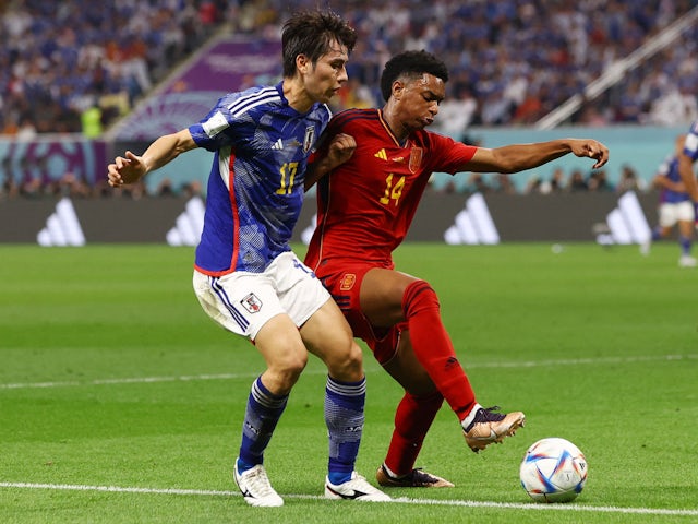 Japan's Ao Tanaka in action with Spain's Alejandro Balde at the World Cup on December 1, 2022 