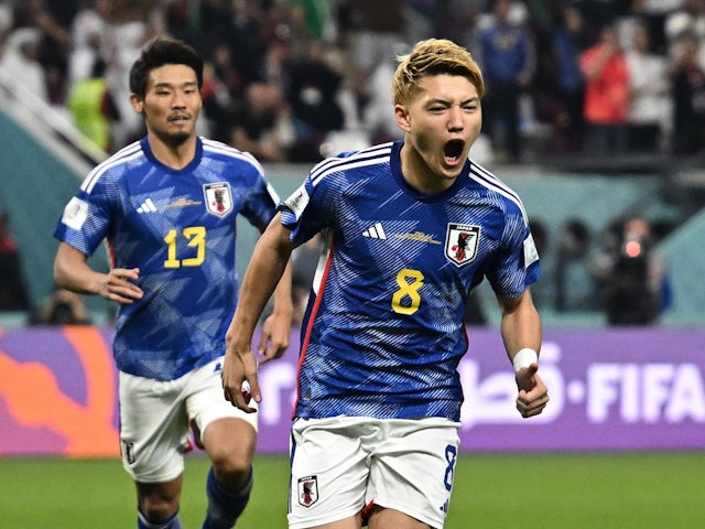 Japan's Ritsu Doan celebrates scoring against Spain at the World Cup on December 1, 2022