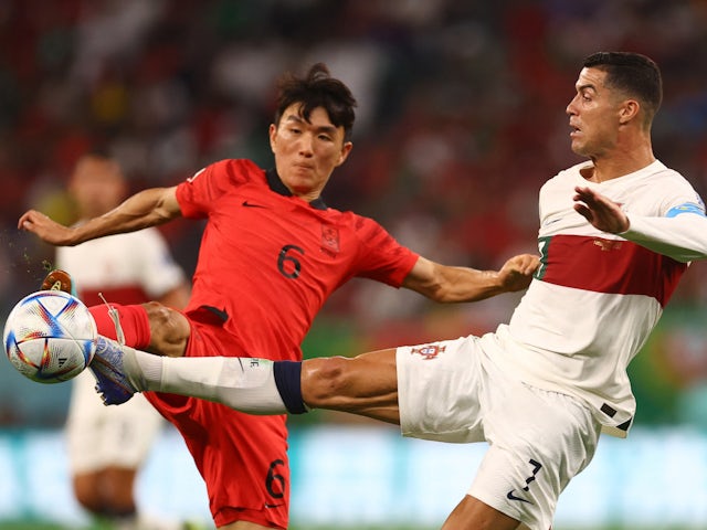 Portugal's Cristiano Ronaldo in action with South Korea's Hwang In-beom at the World Cup on December 2, 2022
