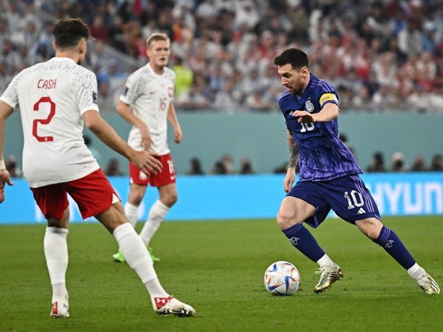 Argentina's Lionel Messi in action with Poland's Matty Cash at the World Cup on November 30, 2022