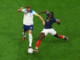 England's Harry Kane in action with France's Dayot Upamecano at the World Cup on December 10, 2022