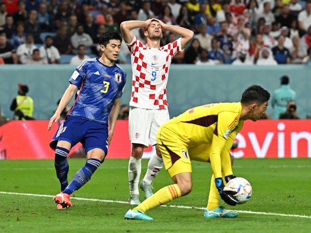 Japan's Shuichi Gonda in action as Croatia's Andrej Kramaric at the World Cup on December 5, 2022