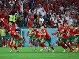 Morocco players celebrate beating Spain in the penalty shootout on December 6, 2022