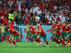 Morocco players celebrate beating Spain in the penalty shootout on December 6, 2022