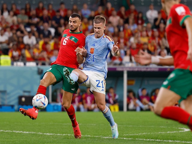 Morocco defender Romain Saiss plays for the ball against Spain midfielder Dani Olmo on December 6, 2022