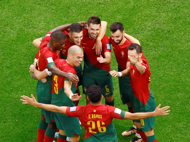 Portugal's Raphael Guerreiro celebrates scoring their fourth goal with teammates on December 6, 2022