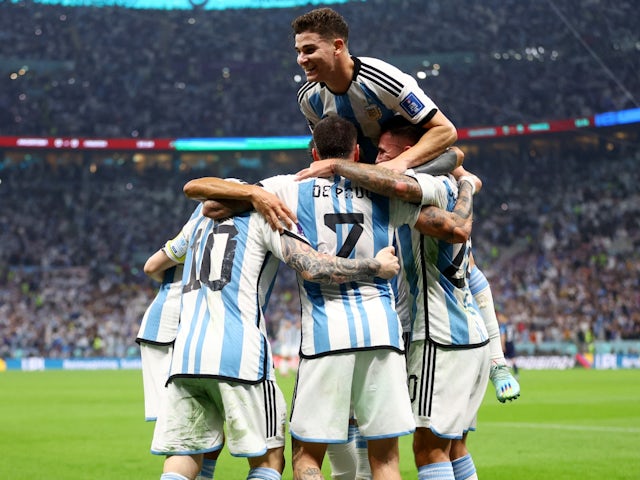 Argentina's Lionel Messi celebrates scoring their first goal with Julian Alvarez and teammates on December 13, 2022