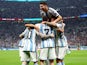 Argentina's Lionel Messi celebrates scoring their first goal with Julian Alvarez and teammates on December 13, 2022
