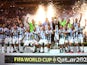 Argentina's Lionel Messi celebrates with the trophy and teammates after winning the World Cup on December 18, 2022