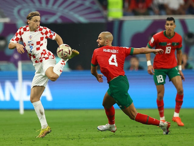 Croatia's Lovro Majer in action with Morocco's Sofyan Amrabat at the World Cup on December 17, 2022