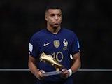 France's Kylian Mbappe poses with his Golden Boot award during the award ceremony after the match on December 18, 2022