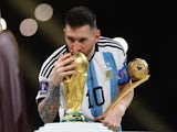 Argentina's Lionel Messi kisses the World Cup trophy after collecting the Golden Ball award on December 18, 2022