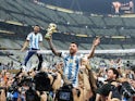 Argentina's Lionel Messi celebrates with the trophy after winning the World Cup on December 18, 2022