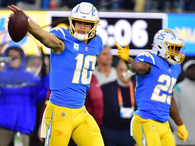 Los Angeles Chargers quarterback Justin Herbert (10) reacts with running back Joshua Kelley (25) after running the ball for first down against the Miami Dolphins during the second half at SoFi Stadium on December 11, 2022