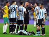 Argentina's Rodrigo De Paul, Gonzalo Montiel, Lisandro Martinez and Nicolas Otamendi appeal to referee Szymon Marciniak as Argentina's Cristian Romero reacts on December 3, 2022