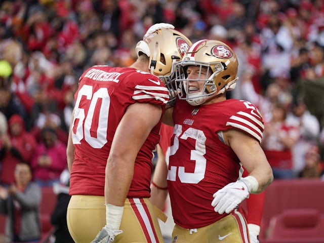 San Francisco 49ers running back Christian McCaffrey (23) is congratulated by offensive tackle Daniel Brunskill (60) after scoring a touchdown against the Tampa Bay Buccaneers in the third quarter at Levi's Stadium on December 11, 2022