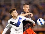 Velez Sarsfield's Maximo Perrone in action with River Plate's Braian Romero on June 29, 2022