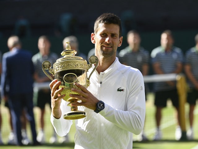 Serbia's Novak Djokovic poses with the Wimbledon trophy after winning the men's singles final against Australia's Nick Kyrgios in July 2022