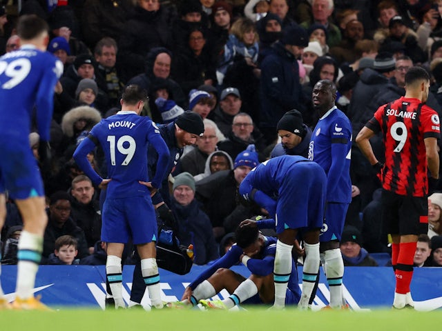 Chelsea's Reece James looks dejected after sustaining an injury as Mason Mount and Kalidou Koulibaly look on on December 27, 2022