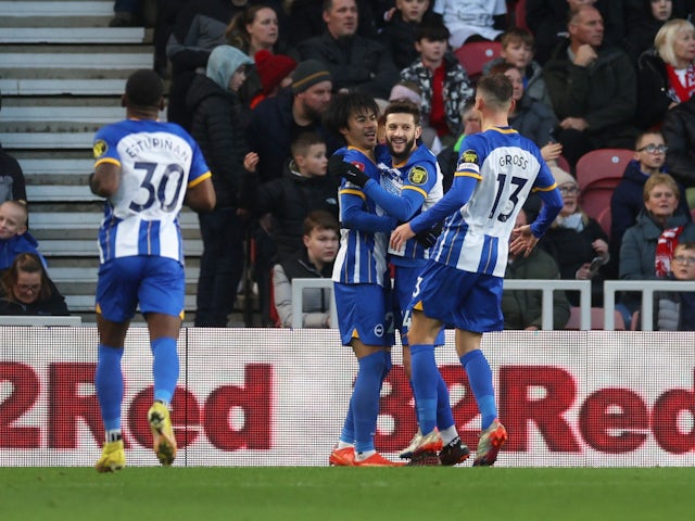 Brighton & Hove Albion's Adam Lallana celebrates scoring their second goal with Kaoru Mitoma and Pascal Gross on January 7, 2023