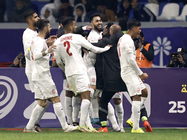Bahrain players celebrate after Qatar's Mohammed Waad scored an own goal and their first on January 10, 2023