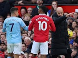Manchester City's Joao Cancelo and Manchester United's Marcus Rashford react along with Manchester City manager Pep Guardiola on January 14, 2023