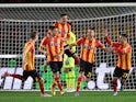 Lecce's Alexis Blin with teammates celebrate after AC Milan's Theo Hernandez scores an own goal and Lecce's first on January 14, 2023