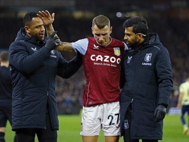 Aston Villa's Lucas Digne receives medical attention after sustaining an injury on January 13, 2023