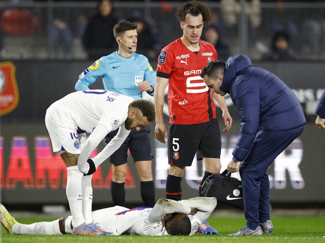 Paris Saint-Germain's (PSG) Nordi Mukiele receives medical attention after sustaining an injury as Neymar and Stade Rennes' Arthur Theate look on on January 15, 2023