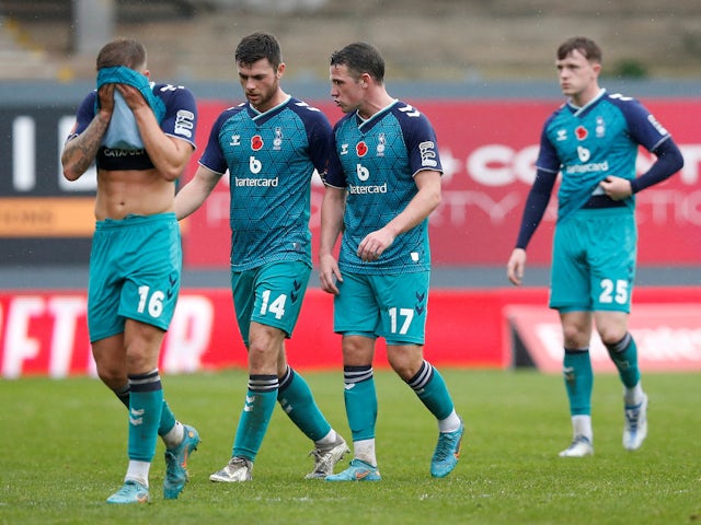 Oldham Athletic's Nathan Sheron, Charlie Cooper and John Rooney look dejected after the match on November 26, 2022