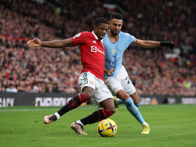 Manchester United's Tyrell Malacia in action with Manchester City's Riyad Mahrez on January 14, 2023