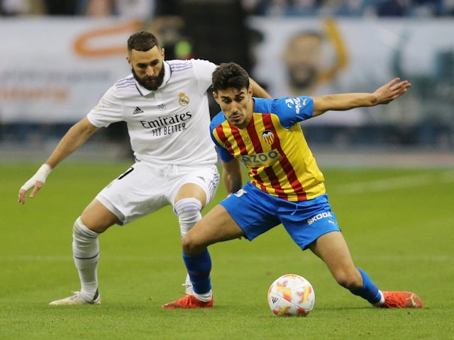 Valencia's Andre Almeida in action with Real Madrid's Karim Benzema on January 11, 2023