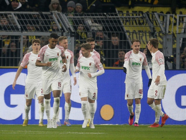 Augsburg's Arne Maier celebrates scoring their first goal with teammates on January 22, 2023