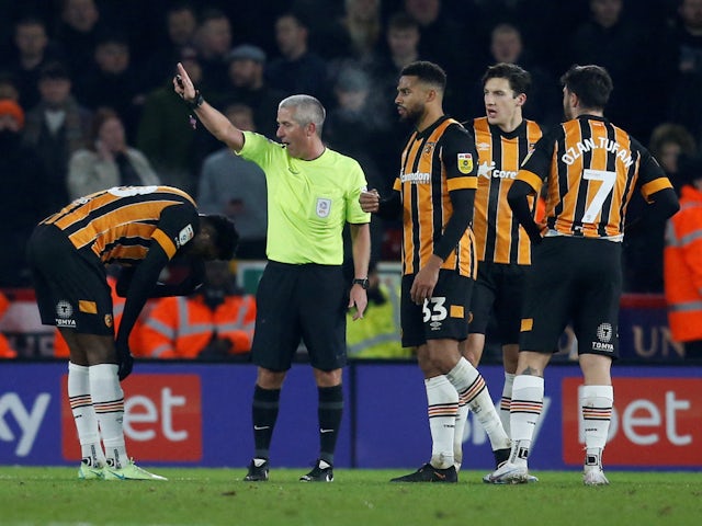 Hull City's Benjamin Tetteh is shown a red card by referee Darren Bond on January 20, 2023