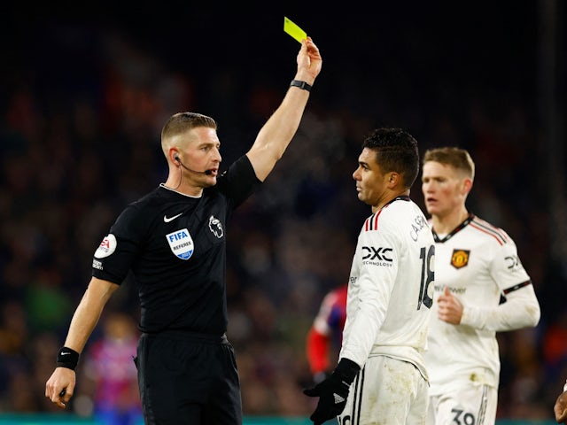 Manchester United's Casemiro is shown a yellow card by referee Robert Jones on January 18, 2023