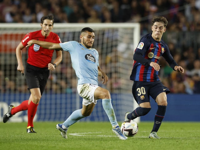 Barcelona's Gavi in action with Celta Vigo's Oscar Rodriguez on October 9, 2022