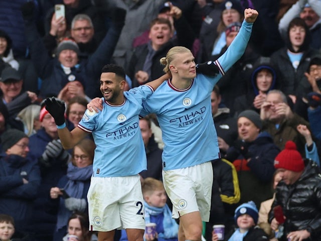 Manchester City's Erling Braut Haaland celebrates scoring their third goal and his hat-trick with Riyad Mahrez on January 22, 2023