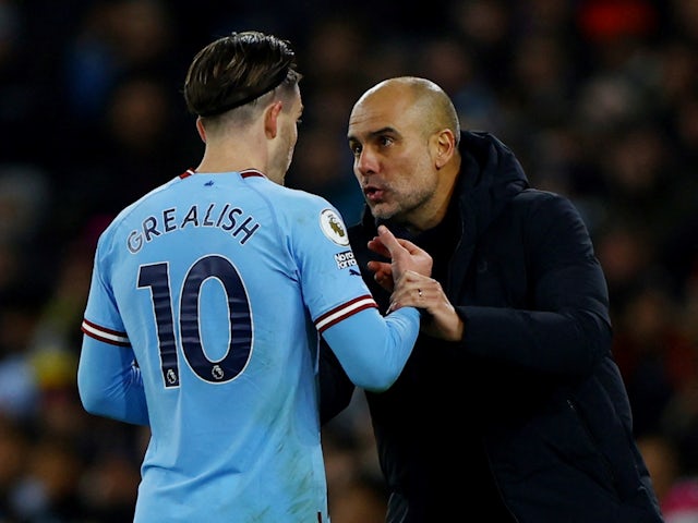 Manchester City manager Pep Guardiola talks to Jack Grealish on January 19, 2023