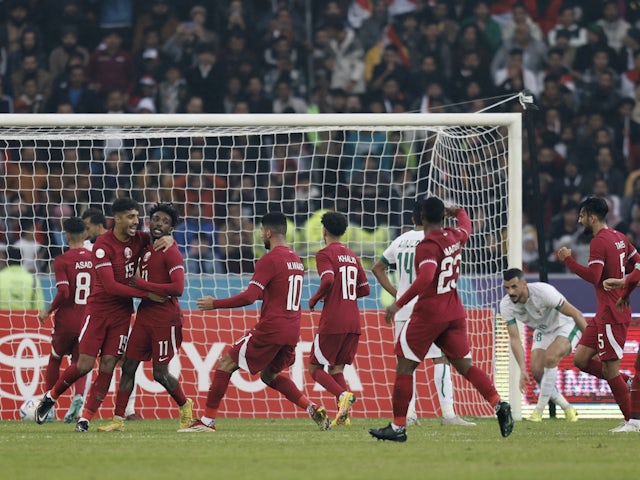 Qatar's Amro Abdelfatah Ali Surag celebrates scoring their first goal with teammates on January 16, 2023