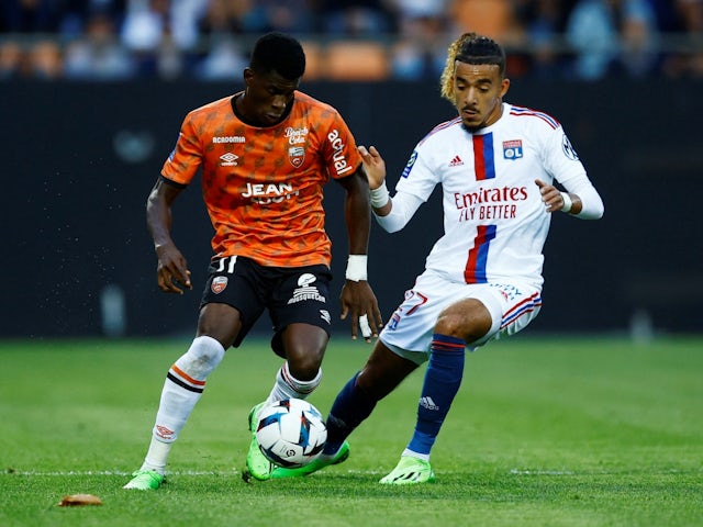 Lorient's Dango Ouattara in action with Lyon's Malo Gusto on September 7, 2022