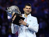Serbia's Novak Djokovic celebrates with the trophy after winning his final match against Greece's Stefanos Tsitsipas on January 29, 2023