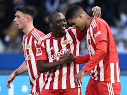 Union Berlin's Danilho Doekhi celebrates scoring their first goal with Jerome Roussillon and Janik Haberer on January 28, 2023
