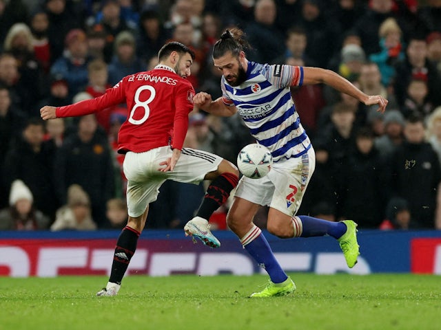 Reading's Andy Carroll in action with Manchester United's Bruno Fernandes on January 28, 2023